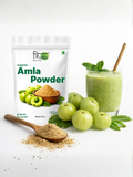 A glass of green amla smoothie with mint leaves, demonstrating a healthy way to consume Trinabha Organic Amla Powder.