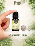 Size comparison of 15ml Trinabha hair oil bottle held between fingers next to a coin.